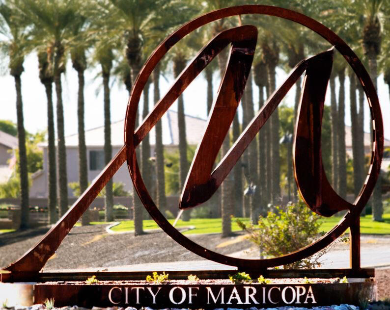 City of Maricopa sign with palm trees in the background, representing legal and business services including process serving.